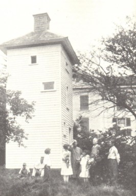 Althea Sherman (left) and her sister Amerlia show Althea’s chimney swift tower to visiting schoolchildren