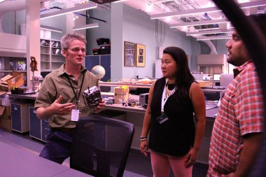 Roland Kays explains to a couple helpers how camera traps work at the North Carolina Museum of Natural Sciences 